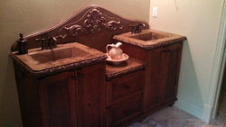 Tiered bathroom vanity made of concrete with antique details.