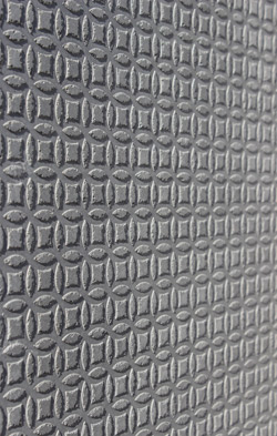 Patterned concrete made using a stamping mat for concrete.