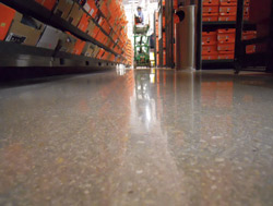 Polished concrete in a sporting goods store has aggregate showing through the shiny concrete floor