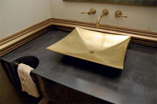Black concrete countertop with a gold sink shows off the geometric patterns that flow through this artists mind.