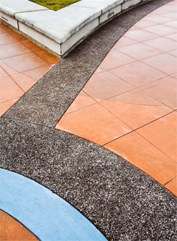 Decorative concrete patio with vibrant red and blue stained concrete