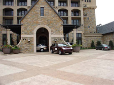 An expansive driveway in front of a hotel that has been stamped and stained with concrete stain.