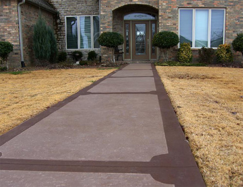 A front-entrance walkway done in ColorJuice Sand and trimmed with two applications of ColorJuice Chocolate. The walkway was finished with ColorJuice Exterior Sealer.