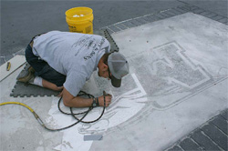Josh Cornwall, a 2003 Concrete Industry Management graduate, works on a decorative concrete project on the Middle Tennesee State University campus in fall 2009. He is etching the pattern of the MTSU logo, which was later stained. The project was a collaboration between members of the ASCC Decorative Concrete Council and the MTSU CIM Program.