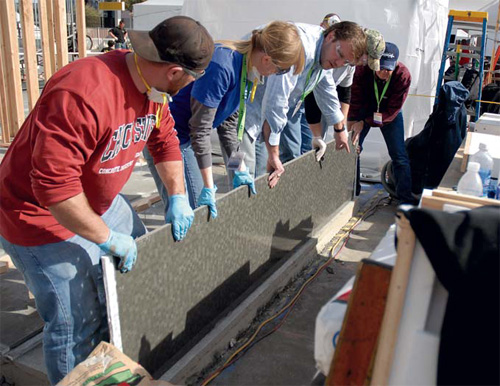 PreiTech Corp. owner and project instructor Mike Eastergard helps CIM students construct a Sept. 11 memorial at 2010 World of Concrete.