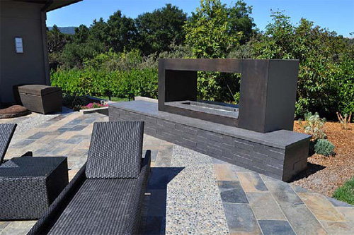 Outdoor space with a fireplace custom made out of concrete.