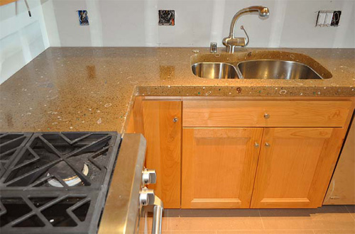 Custom concrete countertops in a light brown color with an under counter sink.
