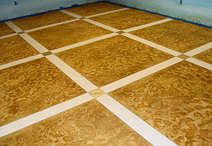 A skip-troweled microtopping with Miracote's architectural water-based stain, Mirastain II. There are two colors used on this floor. One is a liquid pigment (ColorPax-LIP Tiger Gold) and the other is a dry metallic pigment (Pale Gold).