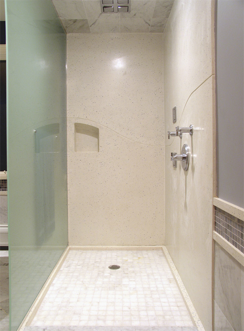 In this shower niche, J&M Lifestyles LLC carried a wave theme in the sink and tub over to the seams in the shower panels to make the seams look purposeful, rather than necessary.