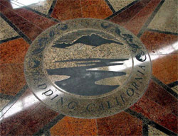 The Swansons incorporated the city seal of Redding into their design for the floor of The Atrium Building after noticing the logo on a manhole cover. Colledi Signs used a photo of the manhole to fashion a set of vinyl sandblasting stencils.