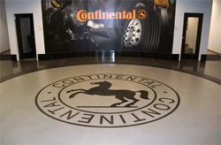 Continental logo that has been stenclied, dyed and polished into this concrete floor.
