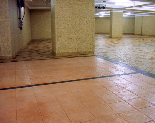 The parking stalls were stamped with Concrete Solutions Ashlar-Italian Slate 12-inch tiles. The black lines were textured with Italian Slate texture mats, and the driveways with English Fieldstone Large stamps.