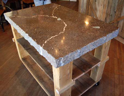 A display table with a blended-color marbled top and hand-chiseled edges.