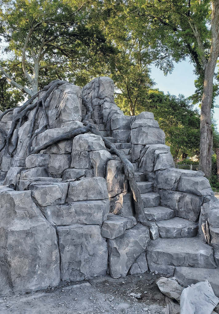 This foam-core construction staircase and fire bowl was built as part of a residential backyard project in Lafayette, Louisiana, done by Bask Pools and Beyond Vertical Concrete. It features 24 hand-carved steps leading to a 39-foot waterslide.