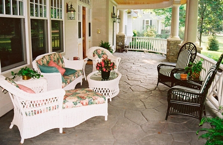 Patio with stamped concrete and different patio chairs.