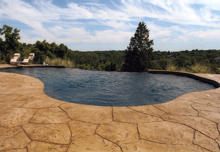 Infinity edge pool that is surround by a custom stamped pool deck.