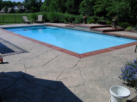 Natural stone concrete stamp pool deck.