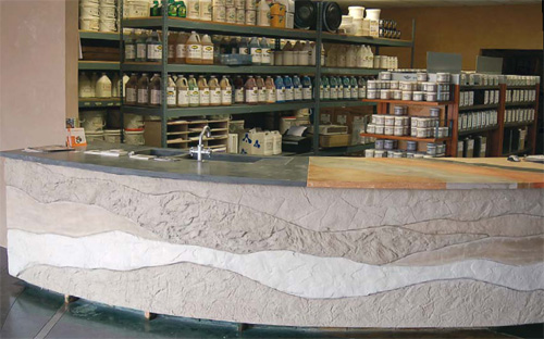 Concrete reception table in an art supply store shows of sediment layers of natural rock wall formations.