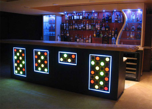 Installed in a residence, this bar includes personalized embeds and fiber optics in the top. It also features a curved concrete wall and concrete soffit to house the lighting. Also unique are the concrete panels with integrated squares and circles. Some of the circles are translucent embeds.