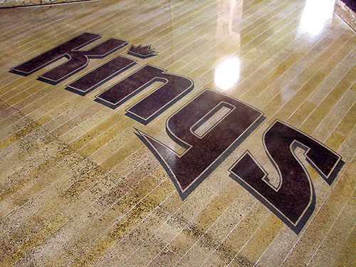 Sacramento Kings logo that has been embossed into a concrete floor by polishing, staining and engraving concrete.