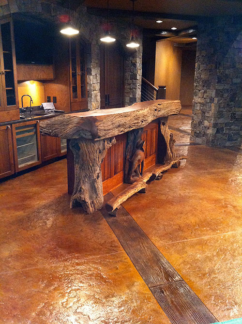 A bluestone-stamped field trimmed with richly stained faux beams, this technique is perfectly suited for any room with an upscale rustic theme.