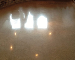 Polishing minus color treatment emphasizes the varied color of the concrete aggregate and the contrast with the gray of the cement while also preserving the vintage terrazzo, Hubartt says.