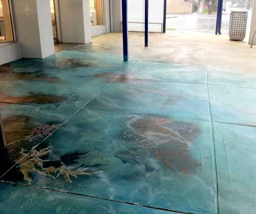 Concrete floor with blues and greens to make it into a mural of a reef.